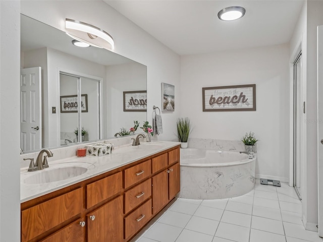 bathroom featuring a bathtub, vanity, and tile patterned floors