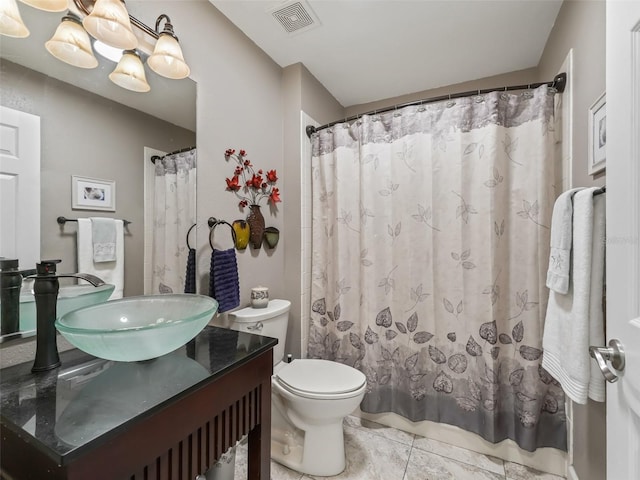 bathroom featuring vanity, a shower with shower curtain, tile patterned flooring, and toilet