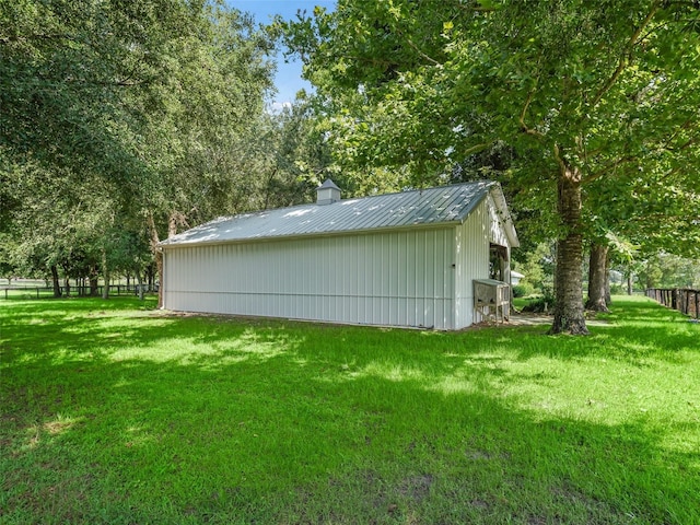 view of outbuilding featuring a lawn