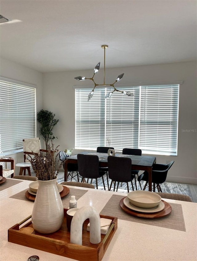 dining room with an inviting chandelier and wood-type flooring