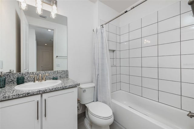 full bathroom featuring toilet, shower / bathtub combination with curtain, and vanity