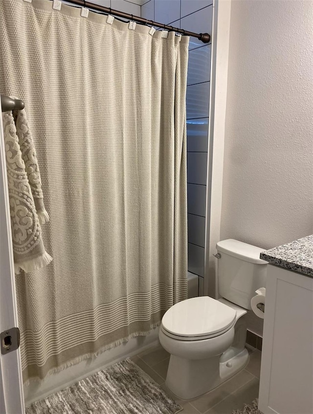 bathroom with vanity, tile patterned floors, and toilet