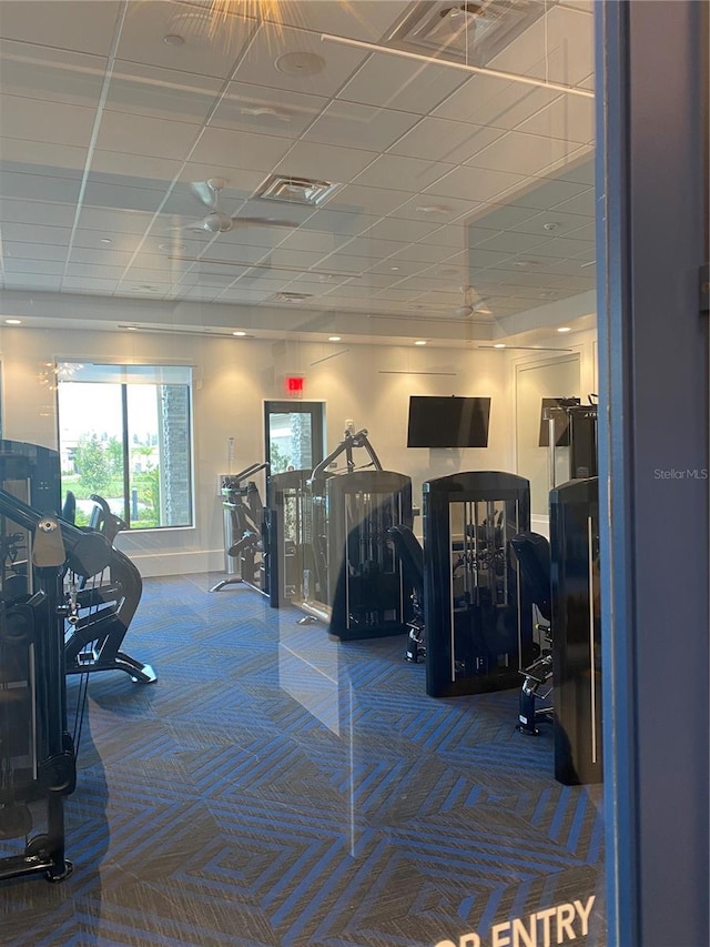 gym with a drop ceiling and carpet floors