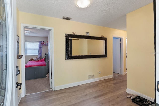 interior space featuring a textured ceiling and hardwood / wood-style flooring