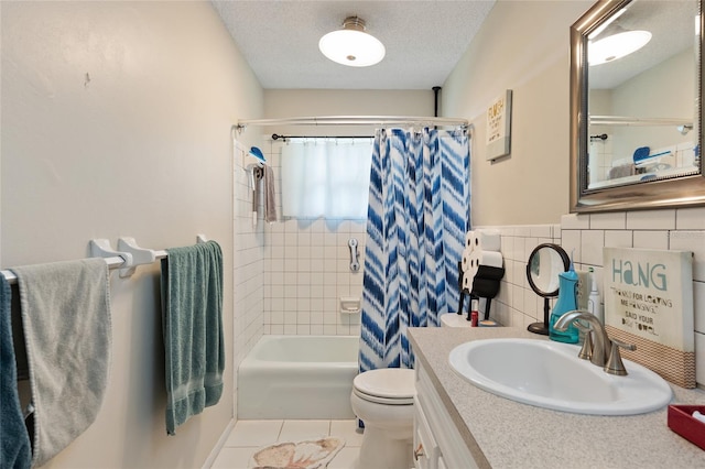 full bathroom with vanity, tile patterned floors, a textured ceiling, shower / bath combination with curtain, and toilet