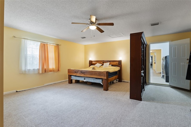 carpeted bedroom with a textured ceiling and ceiling fan