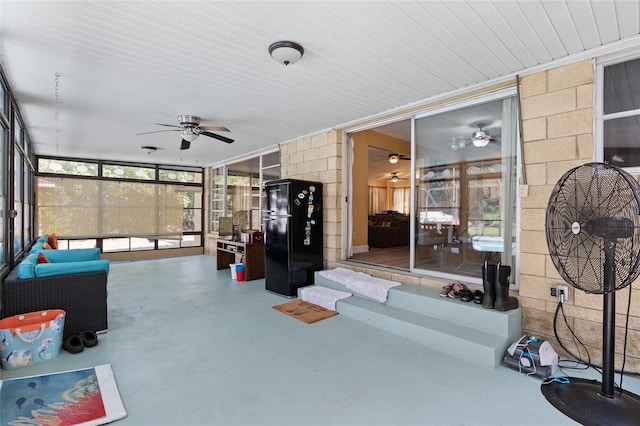 sunroom / solarium featuring ceiling fan and a healthy amount of sunlight