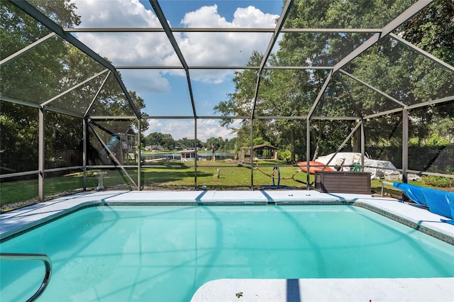 view of pool featuring glass enclosure and a yard