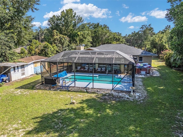 view of swimming pool with glass enclosure, a lawn, and a patio