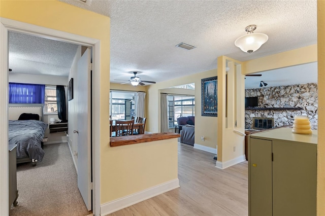 kitchen with plenty of natural light, light colored carpet, and a textured ceiling