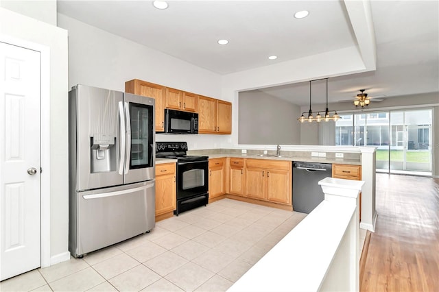 kitchen featuring black appliances, ceiling fan, sink, light hardwood / wood-style flooring, and kitchen peninsula