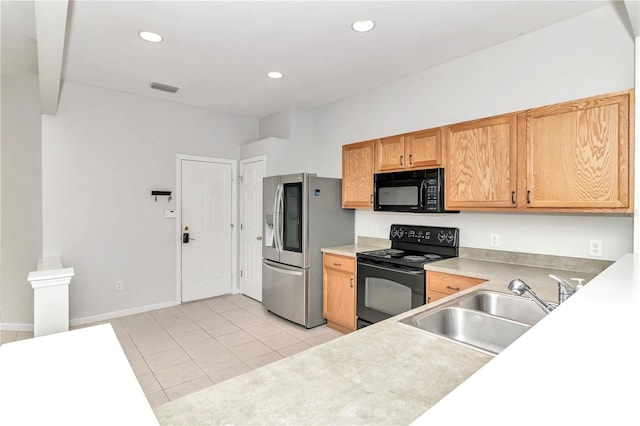 kitchen featuring black appliances, sink, and light tile patterned floors