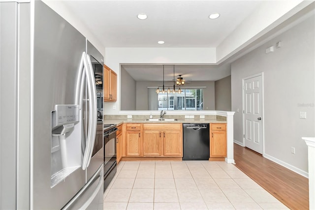 kitchen featuring black appliances, sink, pendant lighting, light tile patterned floors, and ceiling fan