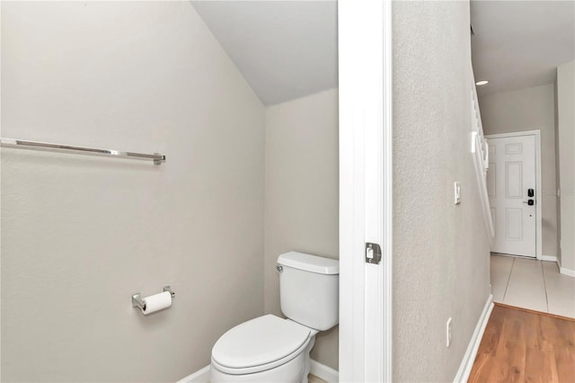 bathroom featuring toilet and hardwood / wood-style floors