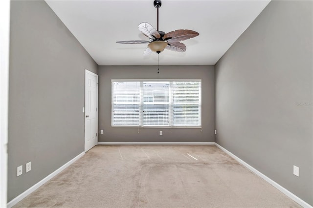 spare room featuring light carpet and ceiling fan