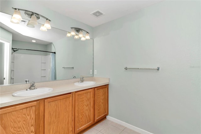 bathroom featuring tile patterned floors and dual bowl vanity