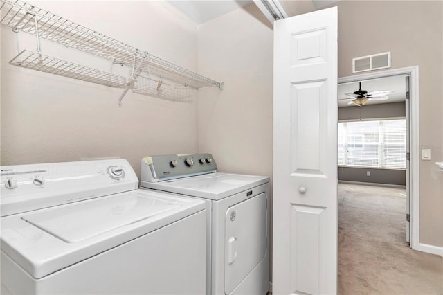 clothes washing area with separate washer and dryer and ceiling fan