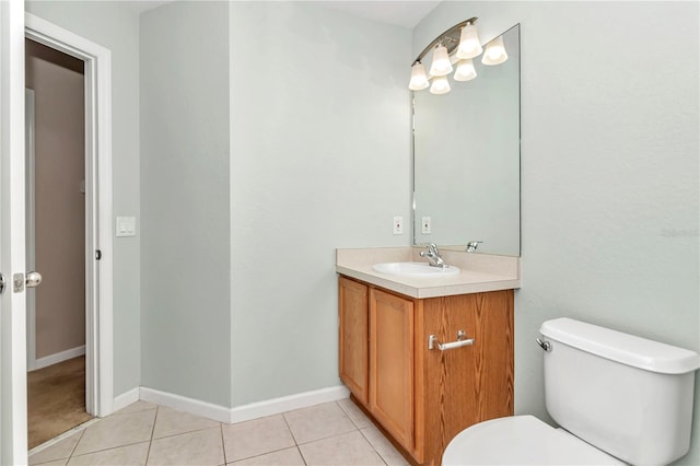 bathroom featuring vanity, tile patterned flooring, and toilet