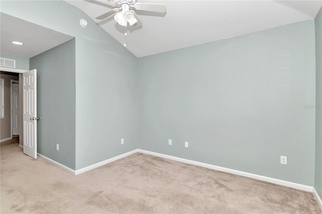 carpeted empty room featuring lofted ceiling and ceiling fan