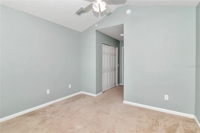 unfurnished room featuring carpet flooring, lofted ceiling, and ceiling fan