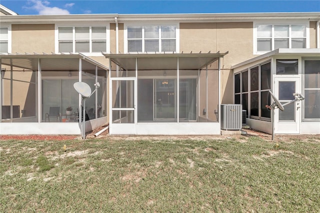 back of house with a sunroom, central AC unit, and a yard