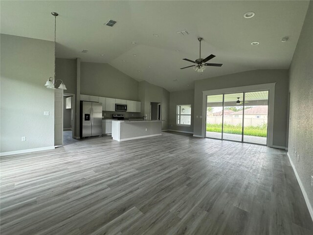 unfurnished living room featuring ceiling fan, light hardwood / wood-style flooring, and high vaulted ceiling