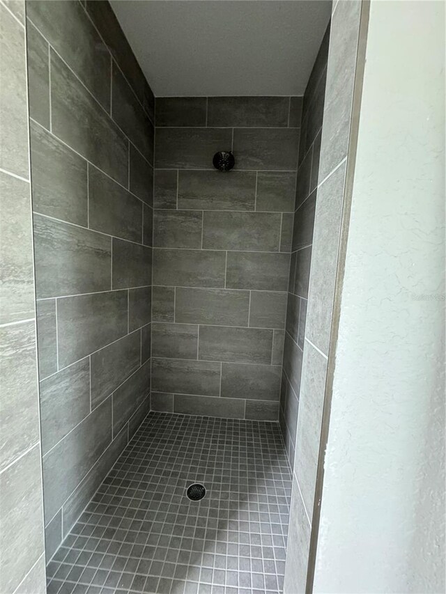 bathroom with a tile shower