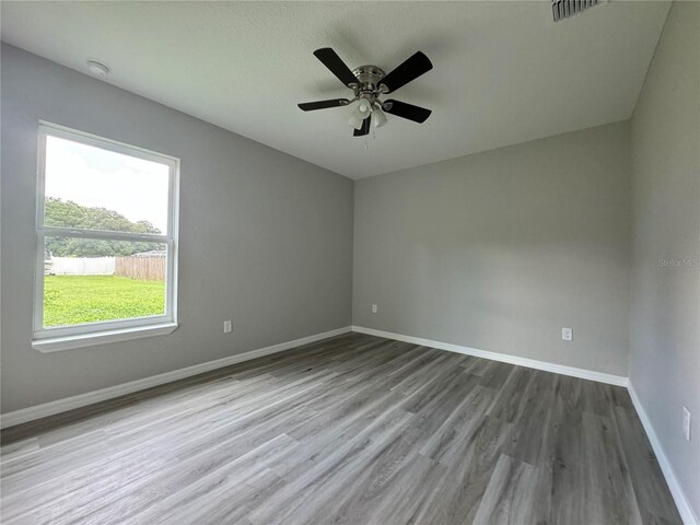 unfurnished room with ceiling fan and wood-type flooring