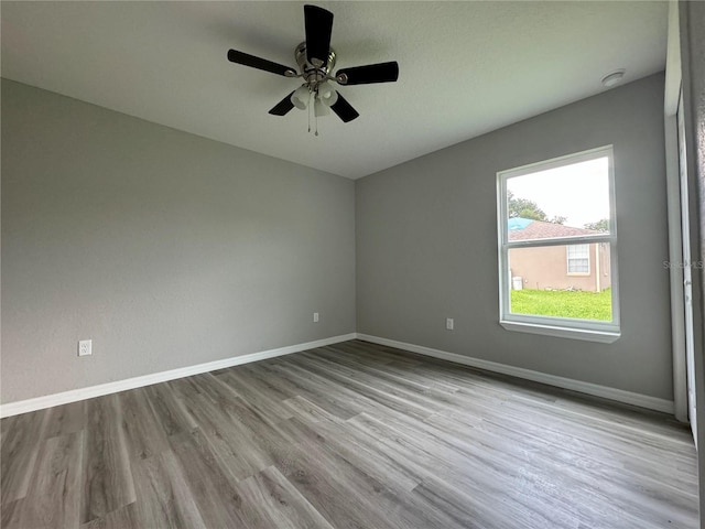 unfurnished room with ceiling fan and hardwood / wood-style flooring