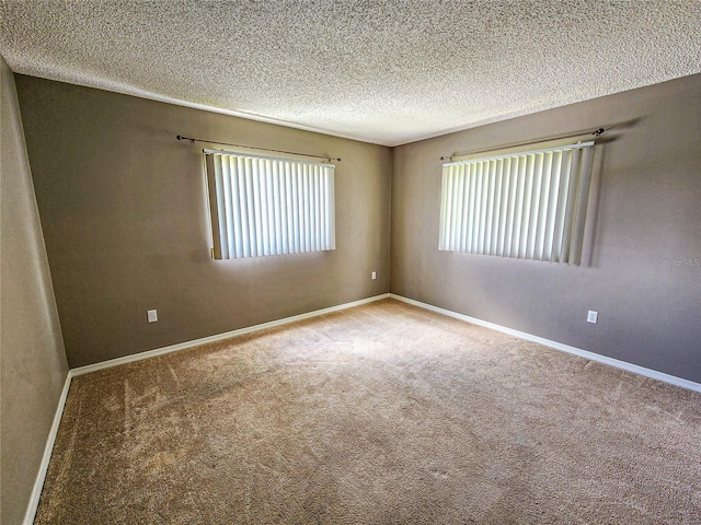 carpeted spare room featuring a textured ceiling