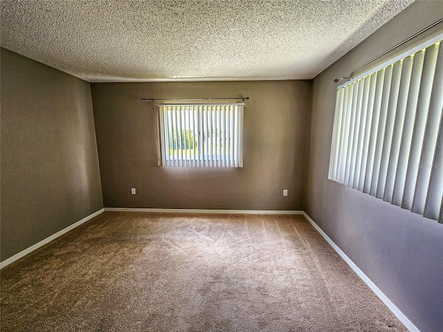 carpeted spare room with a textured ceiling