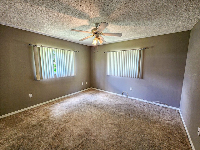 carpeted spare room with a textured ceiling and ceiling fan