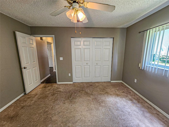 unfurnished bedroom with a textured ceiling, a closet, carpet floors, and ceiling fan