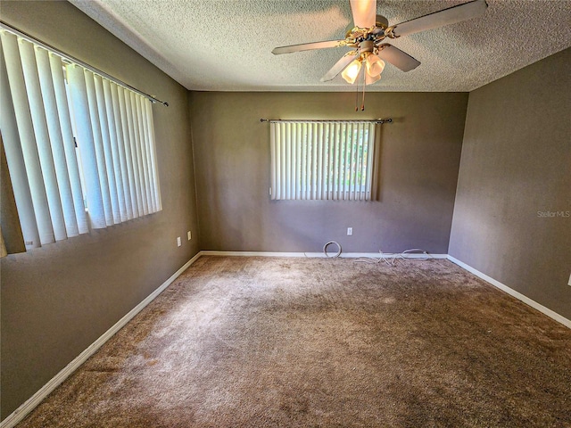 spare room with a textured ceiling, carpet floors, and ceiling fan