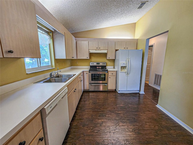 kitchen with dark wood-type flooring, a textured ceiling, vaulted ceiling, and white appliances