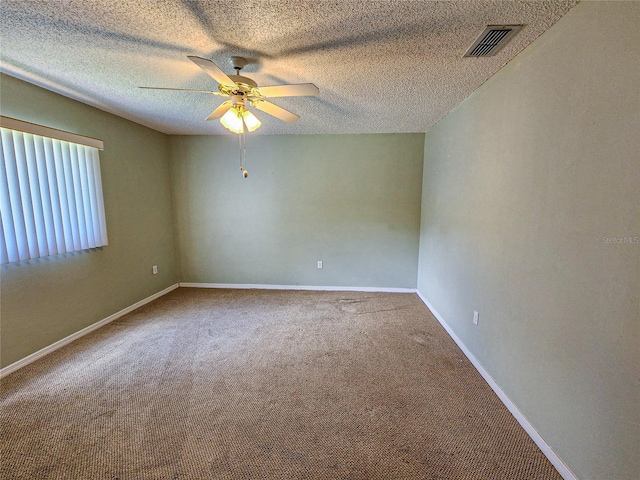 carpeted empty room featuring a textured ceiling and ceiling fan