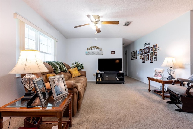 living room with carpet flooring, a textured ceiling, and ceiling fan