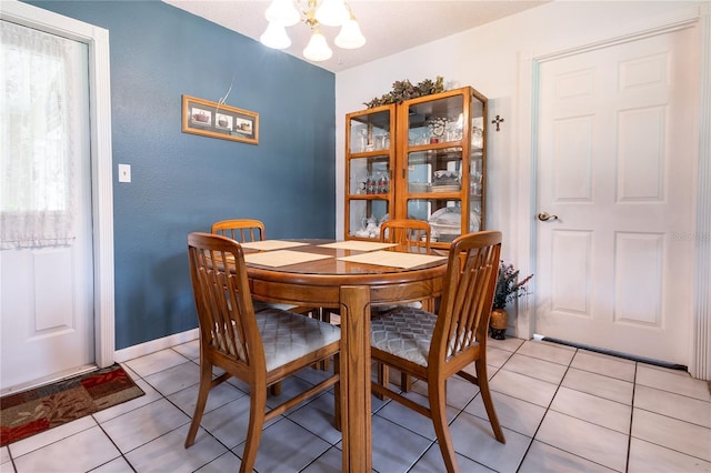 dining space with an inviting chandelier and light tile patterned floors