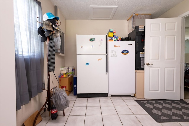 kitchen with white refrigerator and light tile patterned floors