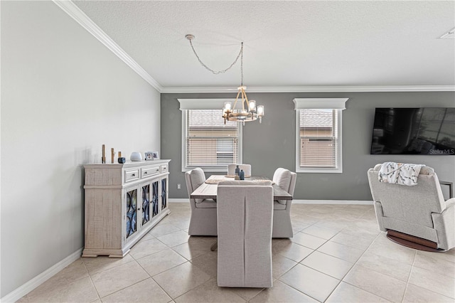 dining space featuring baseboards, ornamental molding, light tile patterned floors, a notable chandelier, and a textured ceiling
