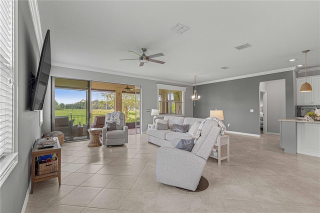living area featuring crown molding, ceiling fan with notable chandelier, visible vents, and baseboards