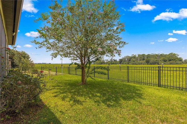 view of yard featuring a rural view and fence