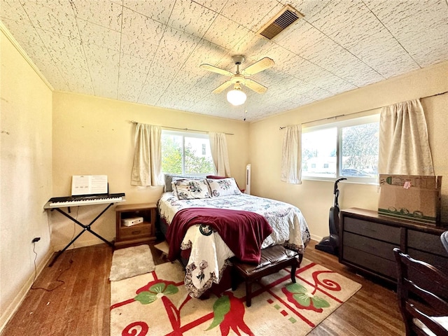 bedroom with ceiling fan and hardwood / wood-style flooring