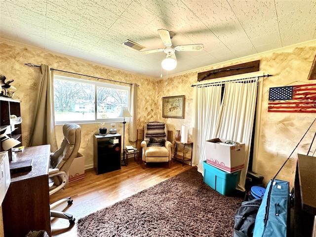 office area featuring ceiling fan, hardwood / wood-style floors, and crown molding