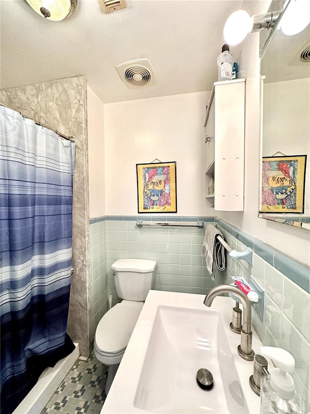 bathroom featuring sink, tile walls, toilet, and curtained shower