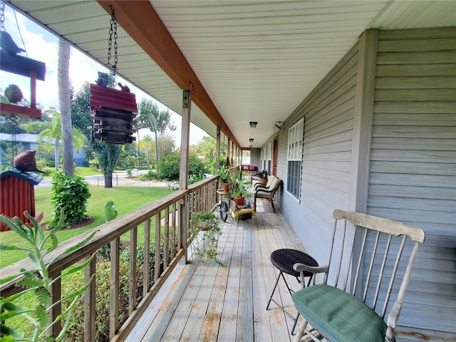 wooden deck featuring a lawn