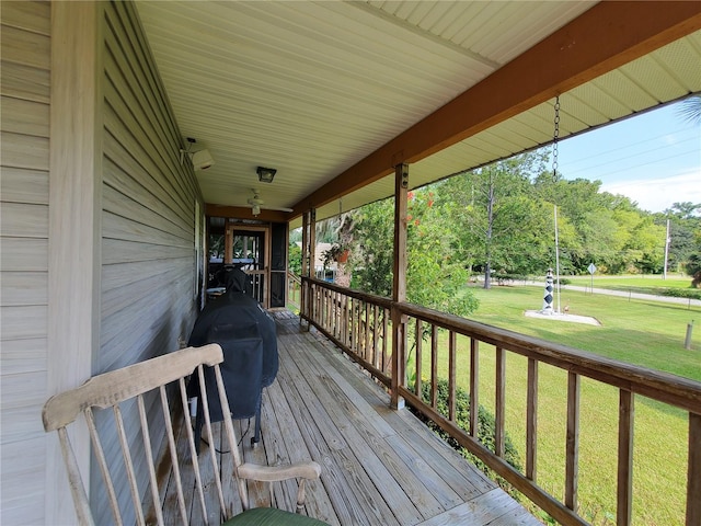 wooden deck featuring a yard and grilling area