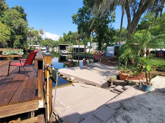 view of patio / terrace with a dock and a water view