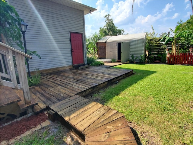 view of yard with a wooden deck and a storage unit