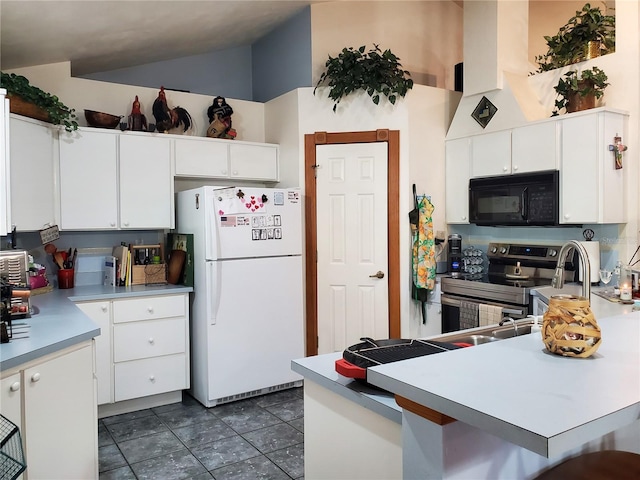 kitchen featuring white cabinets, white fridge, dark tile patterned floors, a towering ceiling, and electric range